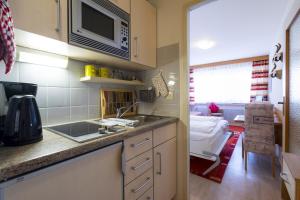 a kitchen with a sink and a microwave at Ferienwohnung Hillgruber in Oberstdorf