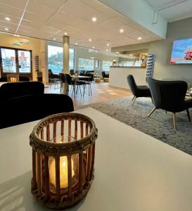 a lobby with a waiting room with chairs and a table at Marina Hotel Lofoten in Svolvær