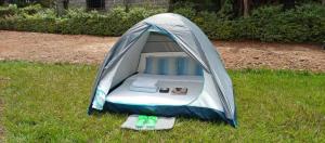 a tent in the grass with two flip flops at Kwetu Home - Sagana PAY BEFORE ARRIVAL in Sagana