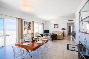 a dining room and living room with a table and chairs at Vinaigrier Hills VI3086 by Riviera Holiday Homes in Nice