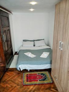 a small bedroom with a bed with two dishes on it at Historic Center Apartment in Braşov