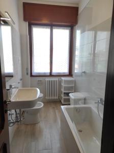a bathroom with a tub and a toilet and a sink at Casa Berizzi - Santa Lucia in Bergamo