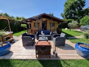 a wooden deck with chairs and a gazebo at Chalet La Romance in Prouilly