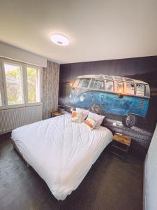a bedroom with a bed with a painting of a van at Kombi By Carl-Emilie in Épinal