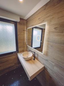 a small bathroom with a sink and a mirror at Kombi By Carl-Emilie in Épinal