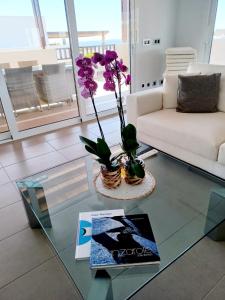 a living room with a white couch and a glass table at VILLA LANZAROTE in Puerto Calero