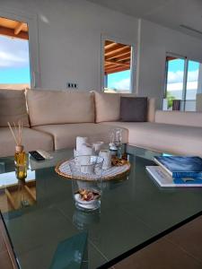 a living room with a couch and a glass table at VILLA LANZAROTE in Puerto Calero