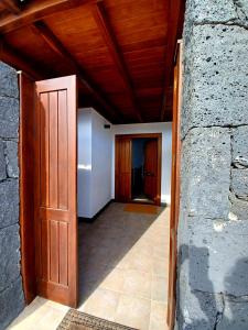 a hallway with a door and a stone wall at VILLA LANZAROTE in Puerto Calero