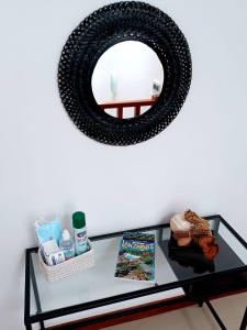 a mirror on a wall with a glass table at VILLA LANZAROTE in Puerto Calero