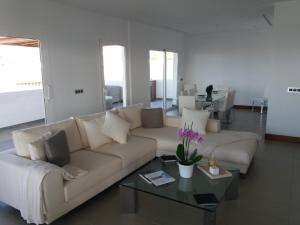 a living room with a couch and a coffee table at VILLA LANZAROTE in Puerto Calero