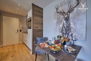 a table with food on it with a picture of a deer at Chalet Gipfelglück in Oberstaufen