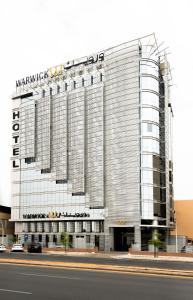 a large building with a sign on top of it at Warwick Riyadh Al Wezarat in Riyadh