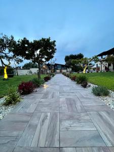 a walkway through a park at dusk at I Lecci Guesthouse in San Felice Circeo