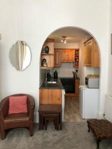 a kitchen with an archway with a couch and a table at Olympia W14 Two-Bedroom Apartment in London