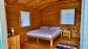 Tempat tidur dalam kamar di Una Kamp