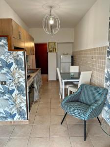 a kitchen and dining room with a table and a chair at I Lecci Guesthouse in San Felice Circeo