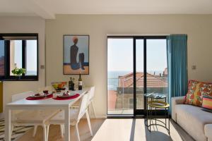 een woonkamer met een tafel en een bank bij Ocean Scene 2 bed Apt in Porto