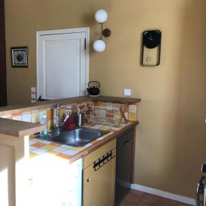 a kitchen with a sink and a counter top at Cottage du vigneron in Vernou-sur-Brenne +60 photos