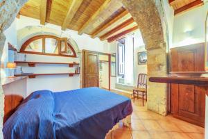 Posteľ alebo postele v izbe v ubytovaní Ortigia Vicolo Giudecca Flat