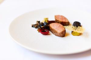 a white plate with some food on it at ABode Canterbury in Canterbury