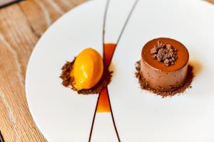 a plate with a chocolate dessert on a table at ABode Canterbury in Canterbury