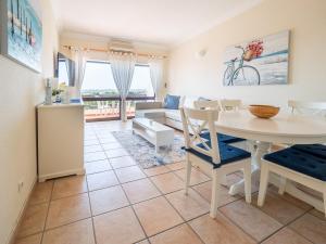 a living room with a table and a couch at Apartamentos Mar-Bel Sol in Vilamoura