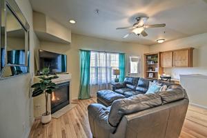 a living room with a leather couch and a fireplace at Windsor Townhome with Balcony and Golf On-Site! in Windsor