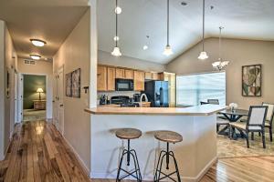 a kitchen and living room with a counter and stools at Windsor Townhome with Balcony and Golf On-Site! in Windsor