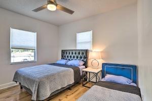 a bedroom with two beds and a ceiling fan at Modern Clearwater Home with Deck 9 Mi to Beach in Clearwater +25 photos