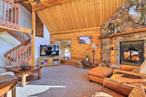 a living room with a fireplace and a tv at Lodge with Indoor Pool, Along Devils Lake Park in Merrimac