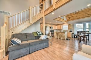 a living room with a couch and a staircase at Lakefront Lexington Escape: Steps to Beach! in Lexington