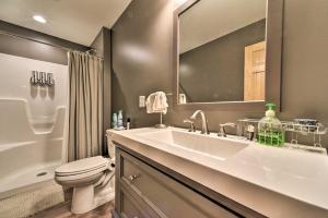 a bathroom with a sink and a toilet and a mirror at Lakefront Lexington Escape: Steps to Beach! in Lexington +25 photos