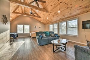 a living room with a couch and a table at Lakefront Lexington Escape: Steps to Beach! in Lexington
