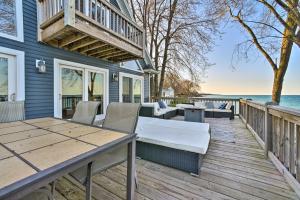 a deck with a table and chairs on a house at Lakefront Lexington Escape: Steps to Beach! in Lexington