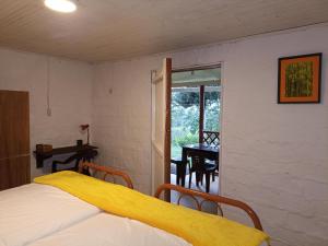 a bedroom with a bed and a window and a table at Casa Rustica La Bella Filandia in Filandia
