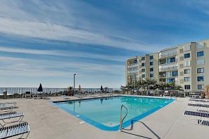 a large swimming pool with chairs and a building at 9400 Bldg #203 in Ocean City