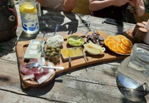 a tray of food on a wooden table at S'Imbragu Farm B&B in Tortolì