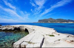 a stone bridge over a body of water at Stabilimento Lido Burrone in Favignana