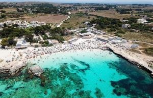 an aerial view of a beach with people in the water at Stabilimento Lido Burrone in Favignana