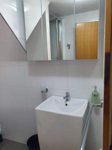 a bathroom with a white sink and a mirror at Old Town Baska in Baška