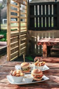 a table topped with three sandwiches and bowls of food at Allangrange Hotel near Inverness in Munlochy