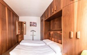 two beds in a room with wooden cabinets at Appartment Waldheim in Sesto