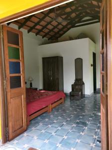 a bedroom with a bed and a tv in it at Villa Agastya in Betalbatim