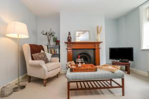 a living room with a chair and a fireplace at Anchor Cottage in Whitby