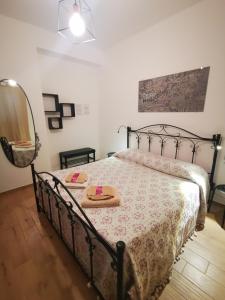 a bedroom with a bed with a table and a mirror at Villetta Delizia in Scopello