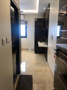 a hallway with a bathroom with a sink and a mirror at L. R RESIDENCY in Kanchipuram