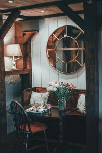 a dining room with a table and a clock on the wall at Allangrange Hotel near Inverness in Munlochy