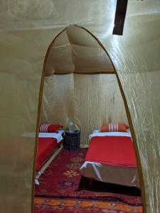 a room with two beds in a tent at Sahara Desert Experience camp in Merzouga
