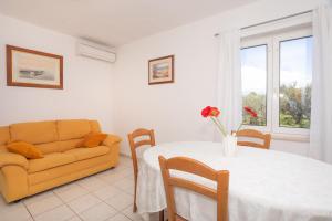 a living room with a table and a couch at MG Holiday Home in Dubravice