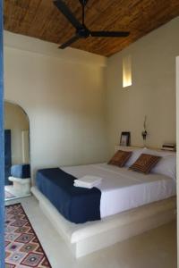 a bedroom with a large bed with a ceiling fan at Casa De Amigos Hotel Boutique in Honda +107 photos